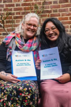 Photo of Pippa Baker-Walsh and Summer Vergara, each holding a copy of the course materials