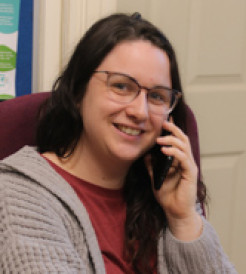 Photo of Emma Eccleston holding a telephone