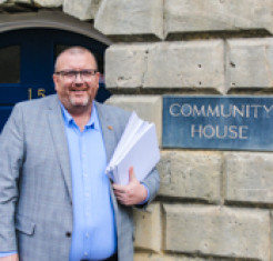 Tim Gwilliam pictured outside the GRCC office, holding a big stack of documents
