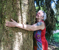 Batsford workshop participant hugging a huge tree trunk