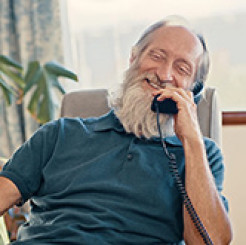 Image of an older man using a landline phone