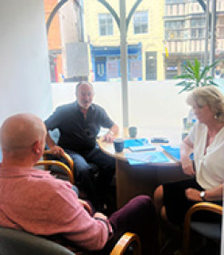 GRCC CEO Barbara Piranty, Chair of Trustees Charles Coats, and Tewkesbury MP Cameron Thomas talking in the MP's Tewkesbury office