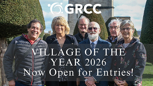 Village of the Year sign, with Parish Clerk Babs Maloney, GRCC Community Development Officer Sabrina Dixon, and award-winning village volunteer Lucy Cameron-Davies.